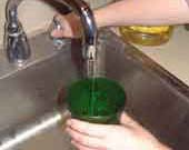 green glass being filled with tap water